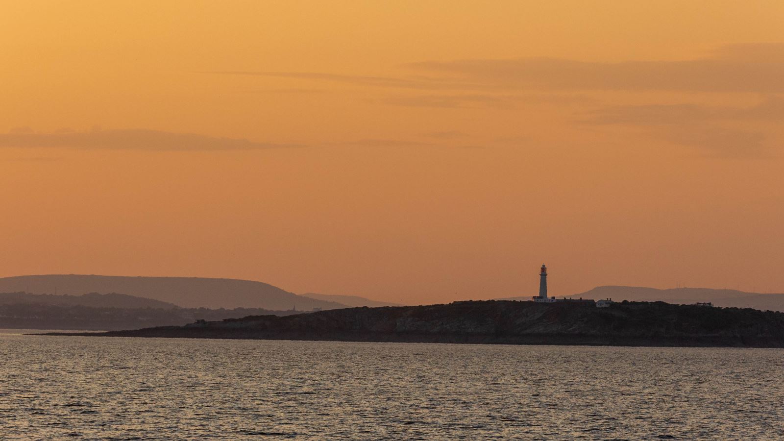 Sunset view across the Bristol Channel to the island of Flat Holm